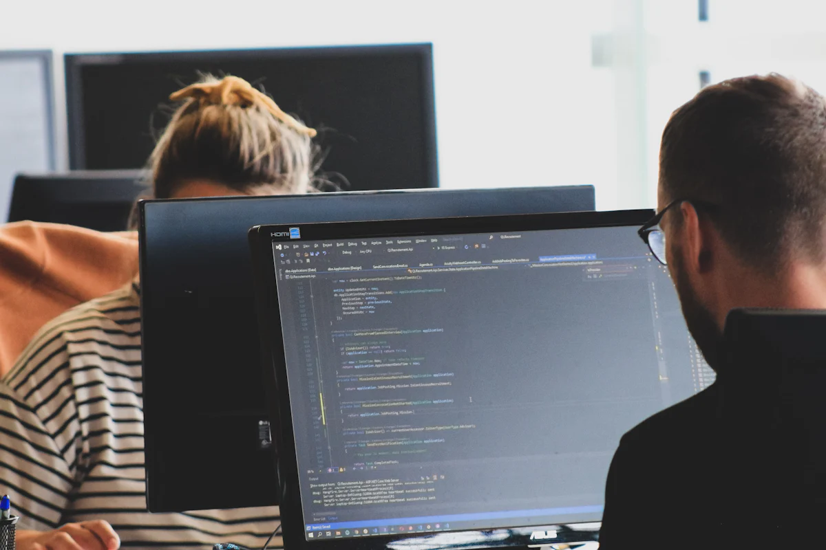 Two developers working on code together